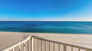 A beach view with a clear sky and calm sea.