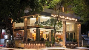 The May D. Wille Corners Hotel with a modern design, featuring a glass facade and a well-lit entrance. - May De Ville Corner Hotel (Hanoi)