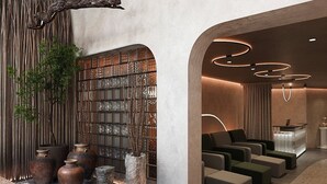 A modern lobby with a reception desk, seating area, and decorative elements like vases and plants. - May De Ville Corner Hotel (Hanoi)