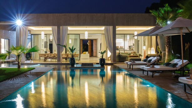 A modern pool area with lounge chairs and a well-lit interior. - NETUMIA (Marrakech)