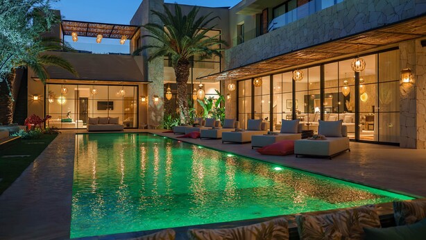 A modern outdoor pool area with a seating area and a covered patio. - EYLINE - luxurious villa with SPA on the Amelkis Golf course near Marrakech (Marrakech)