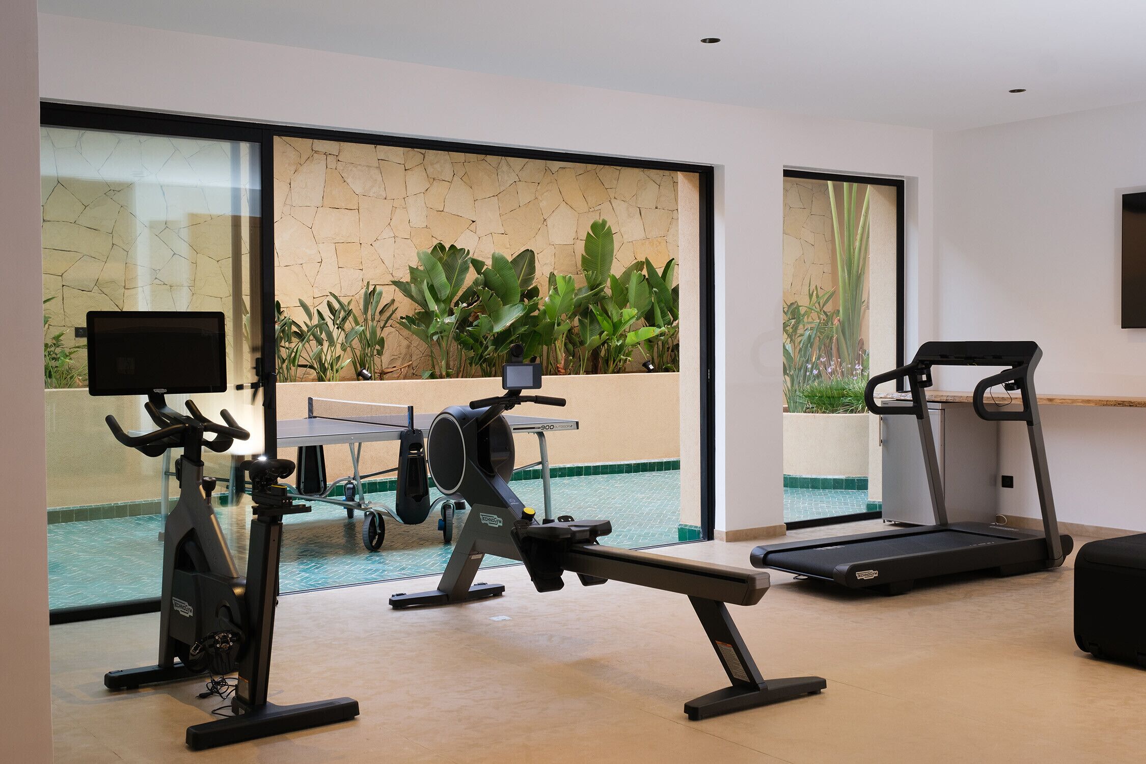 A home gym with exercise equipment, a treadmill, and a stationary bike.