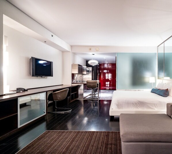 A modern hotel room with a flat-screen TV, a desk with a chair, a bed, and a red wardrobe. - Strip View Studio • Balcony • No Resort Fee • Free Parking • TD30 (Las Vegas)