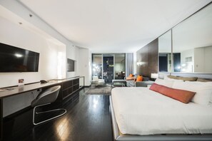 A modern hotel room with a large bed, a desk with a chair, a TV, and a large mirror. - Strip View Studio • Balcony • No Resort Fee • Free Parking • TH24 (Las Vegas)