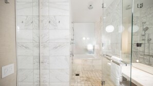A modern bathroom with a glass-enclosed shower, a bathtub, and a vanity with a mirror. - SVS: Strip View Studio | Open Balcony | Full Size Fridge | Palms Place (Las Vegas)