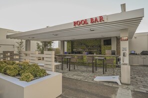 A pool bar with outdoor seating, a counter with bar equipment, and an emergency phone. - Strip View Studio • Balcony • No Resort Fee • Free Parking • TH24 (Las Vegas)