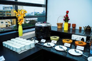 A buffet setup with various dishes and utensils. - Spree Maati Jungle Resort (Manpur)