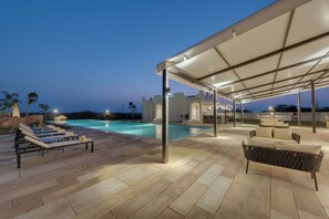 A poolside area with lounge chairs and a covered seating area. - The Fern Sattva Resort Little Rann of Kutch, Series by Marriott (Dasada)