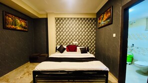 A modern hotel room with a bed, a red headboard, and a large window. - Hotel Uday Palace (Indore)