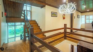 A wooden staircase with a wooden railing leading to an upper floor. - Hotel Riviera By Mount view (Anantnag)