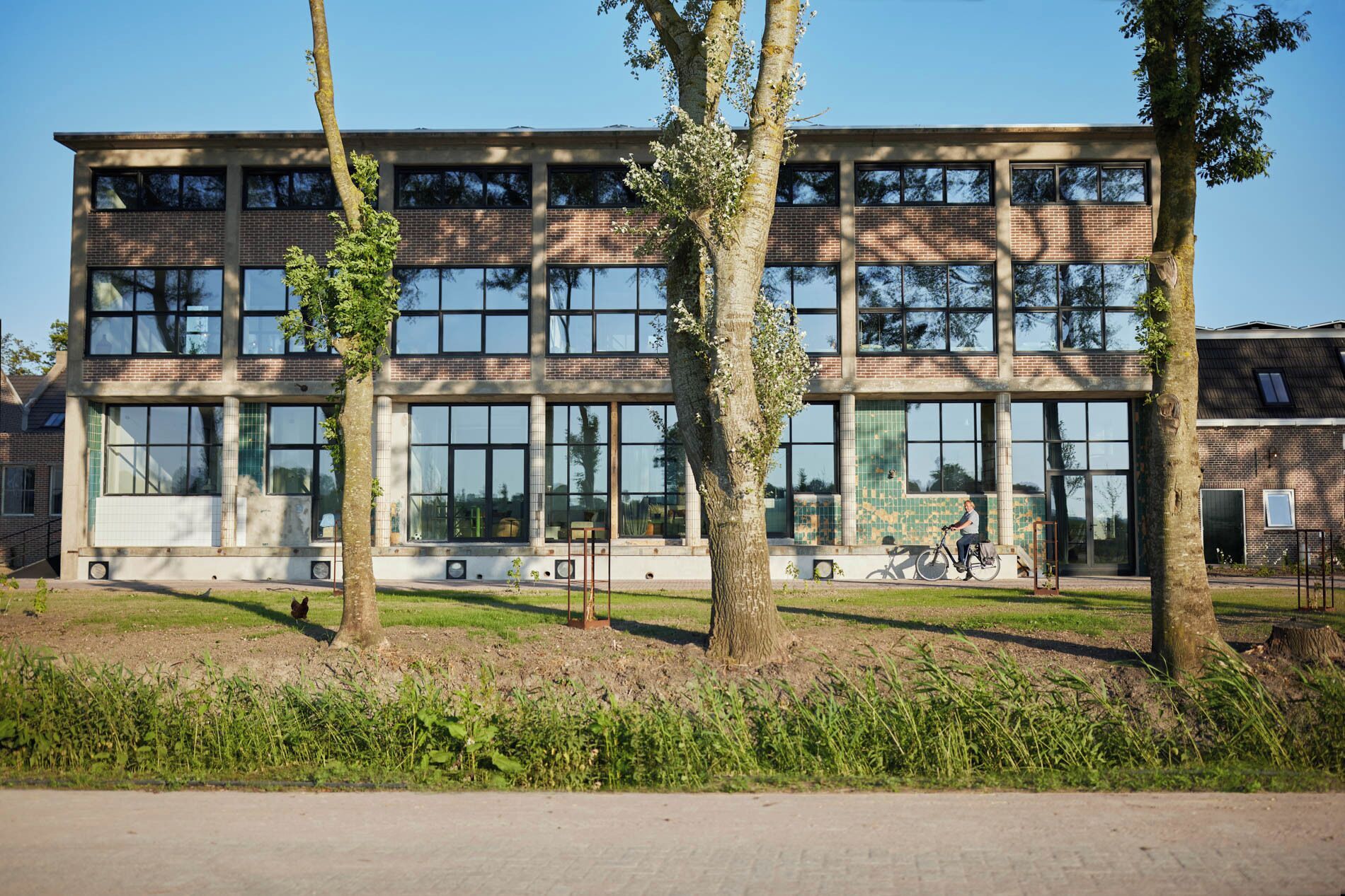 A modern building with large windows and a brick facade.