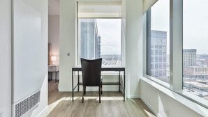 A modern room with a large window, a desk, and a chair.