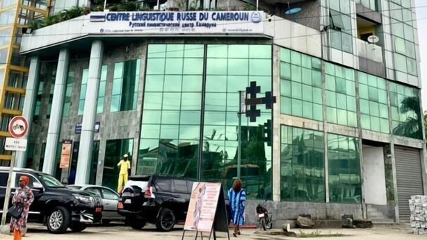 A modern building with a glass facade and multiple balconies. - Riyad City (Douala)