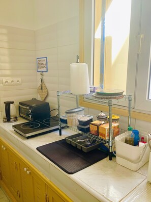 Fridge, stovetop, electric kettle, cookware/dishes/utensils