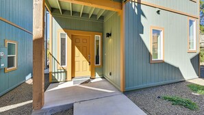 A two-story building with a wooden front porch, a front door, and a small window on the upper floor. - 2 Mi to Dtwn Flagstaff: Home w/ Balcony! (Flagstaff)