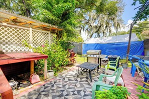 Enjoy al fresco dining and relaxation in this inviting patio area with a barbecue grill, table, and comfortable seating.