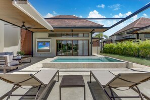 A modern house with a swimming pool, outdoor seating, and a large window overlooking the pool. - Luxury Cap Cana Villa With 3 Bedrooms Plunge Pool Maid and Golf Course Access (Punta Cana)