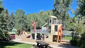 A playground with slides, climbing structures, and picnic tables. - Mtn Views and a Short Walk to Gondola, SV13E (Vail)