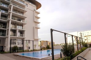 Pool - Oasis Grove: Stylish 2BR Retreat in Masdar City (Abu Dhabi)