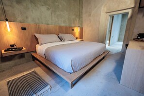 A modern bedroom with a wooden bed frame, a bedside table, and a hanging light fixture. - Casa 1800 Oaxaca Boutique Hotel (Oaxaca)