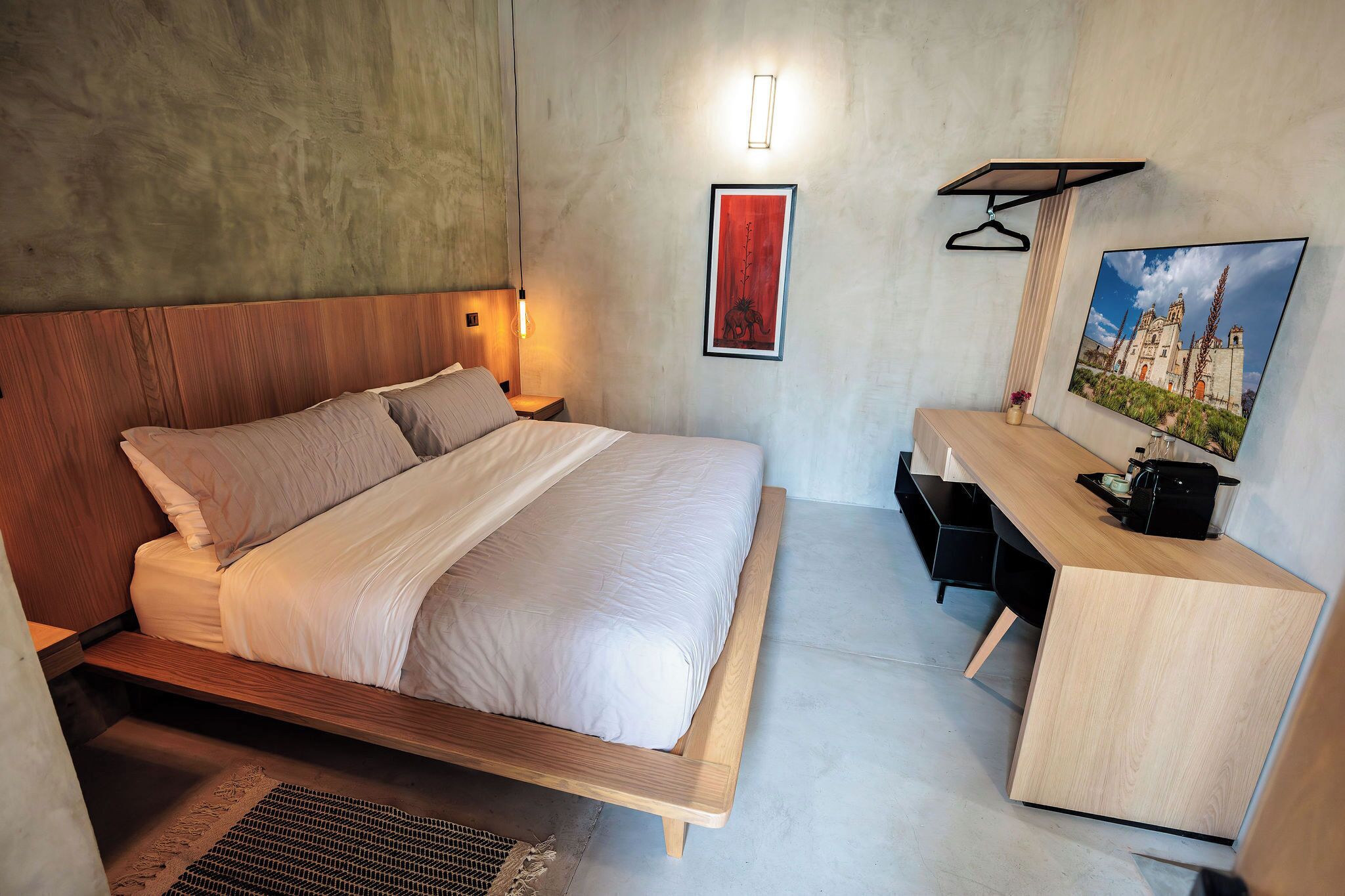 Un dormitorio moderno con una cama de madera, una mesita de noche y un escritorio con una silla.