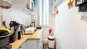 A compact kitchen with a sink, stove, and various utensils.
