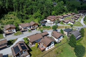 A residential area with multiple houses, each featuring a sloped roof and a front porch. - Alpine Chalet in Wald im Pinzgau for 12 (Wald im Pinzgau)