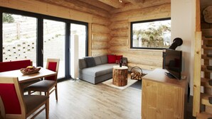 A cozy log cabin interior with a dining area, sofa, and TV. - Chalet in Ladis by Ski Slope & Sonnenbahn (Ladis)