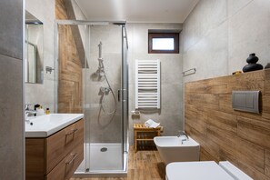 A modern bathroom with a glass-enclosed shower, a wooden vanity, a bathtub, and a small window. - Ornak 7 (Zakopane)