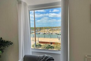Enjoy a serene view of the marina from this room's large window.