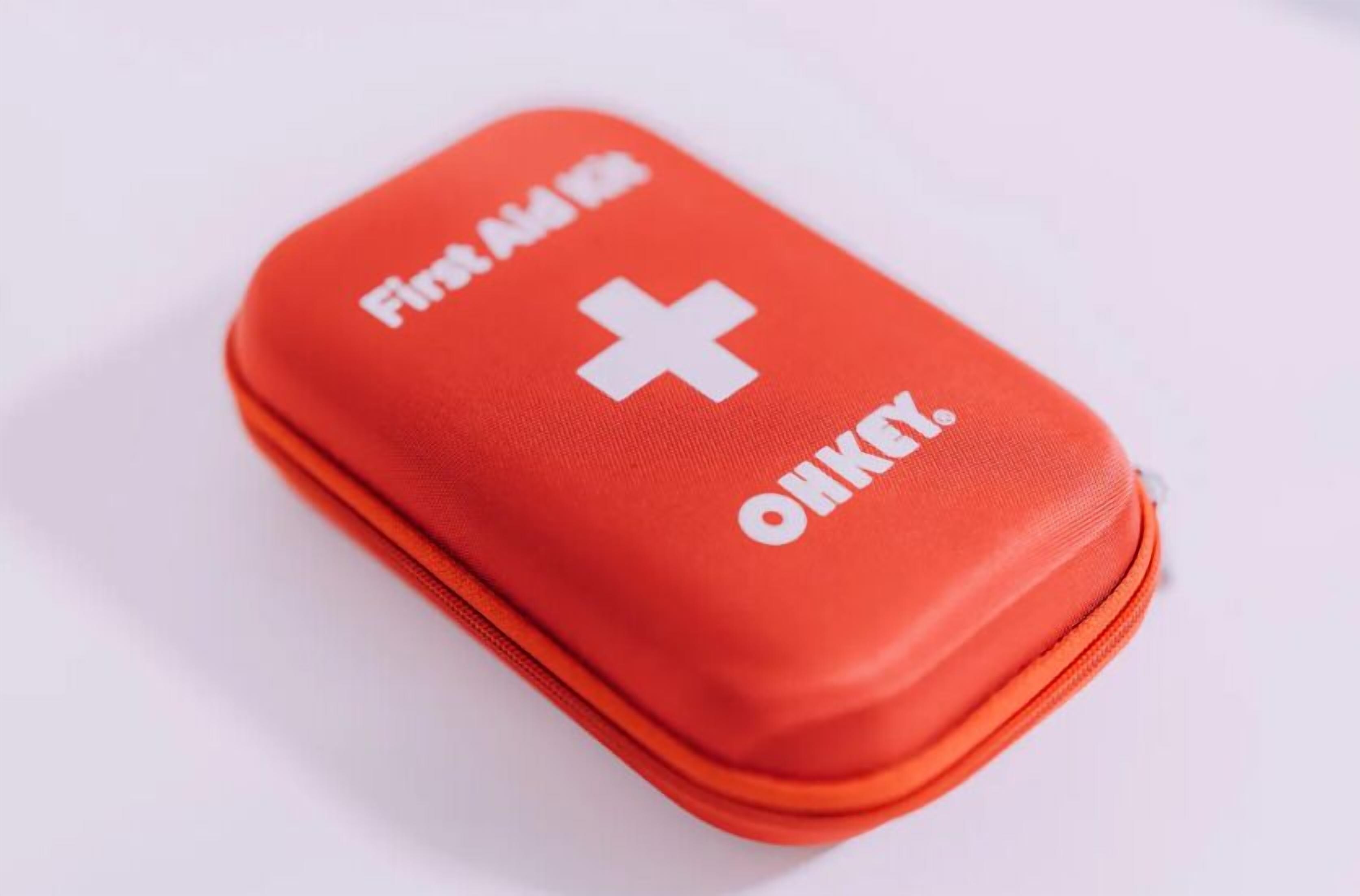 A red first aid kit with a white cross and text.