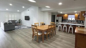 A modern apartment with a dining area, kitchen, and living room. - POOL House+Garage. Bring your Bikes! + 3Bed/2Bath
 (Port Orange)