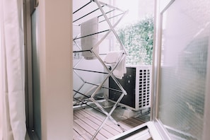 Enjoy the serene view from your balcony, complete with a convenient drying rack for your towels.