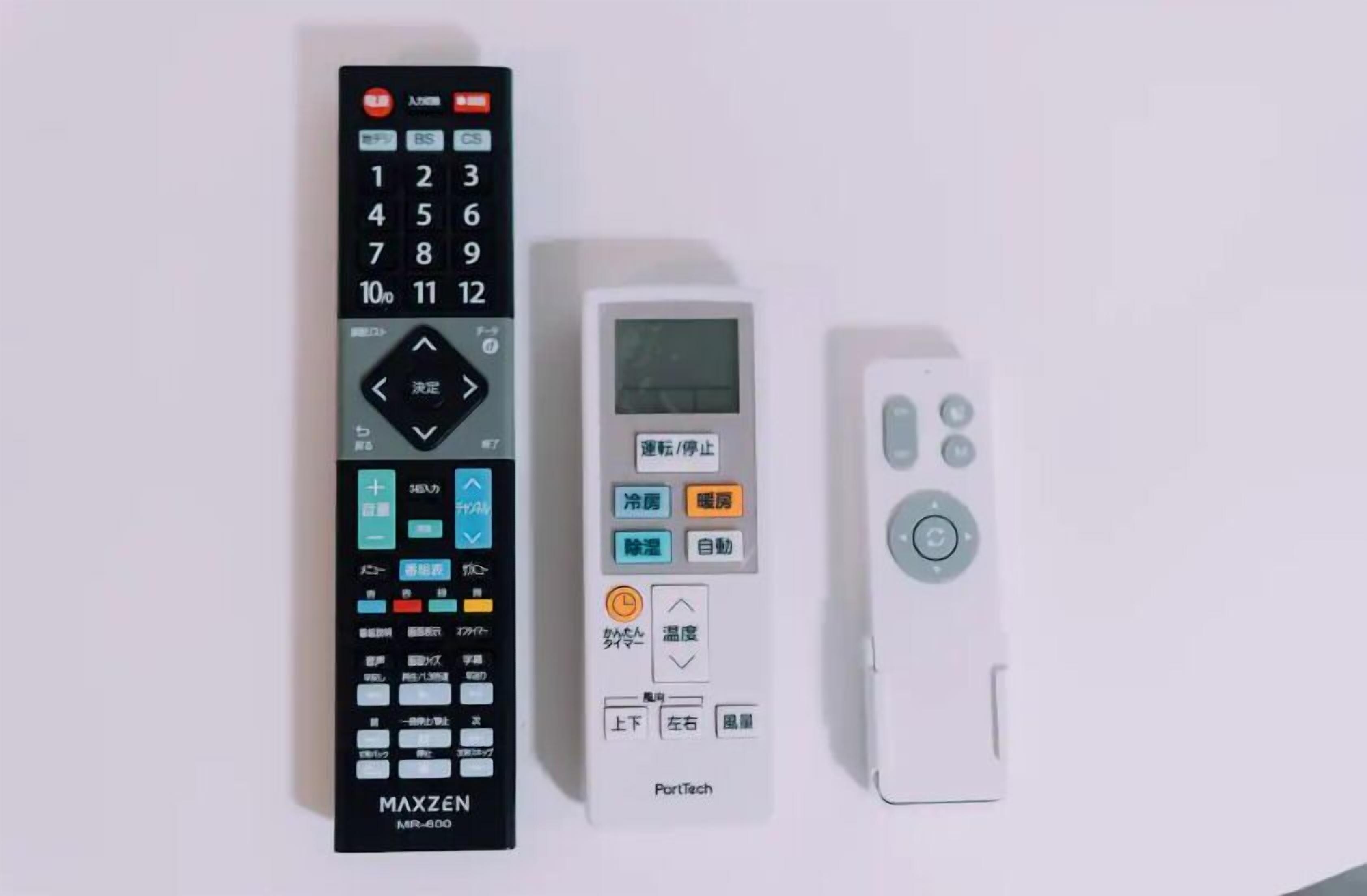 Three remote controls: a black MAXZEN MR-600, a white PortTech remote, and a white remote with a circular button layout.