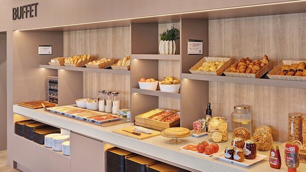 A buffet area with various food items and condiments. - B&B Hotel MADRID Carabanchel (Madrid)