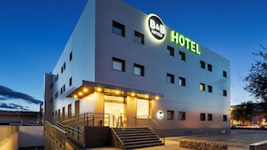 A modern B&B hotel with a prominent illuminated sign, a staircase leading to the entrance, and a well-lit facade. - B&B Hotel MADRID Carabanchel (Madrid)