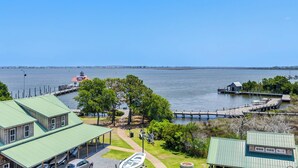 A waterfront property with a gazebo, a small boat, and a lighthouse in the background. - The Ivory Pearl Room/With the best rooftop view in Manteo! (Manteo)
