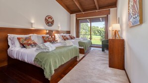 A bedroom with two beds, a wooden ceiling, a large window, and a view of greenery. - Ponte de Lima Chalet Pool & Golf (Feitosa)
