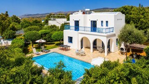 A two-story white building with a pool, outdoor seating, and a view of the landscape. - Villa Artemis - Four Bedroom Villa, Sleeps 8 (Peyia)