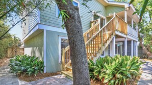 A two-story house with a front porch, a staircase, and a tree in the foreground. - Large House w Pool Table, close Restaurants + Beach Access less than 1000 FT (Tybee Island)