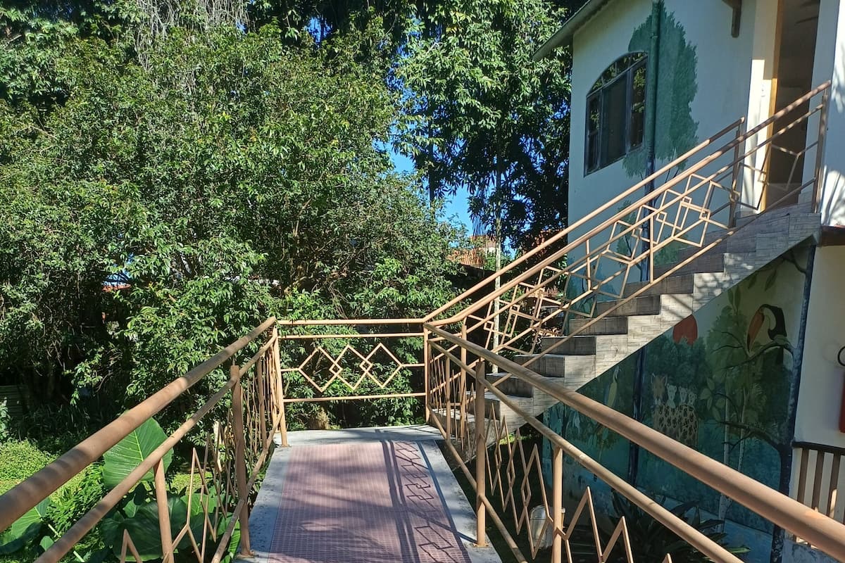 A staircase with metal railings leading to a building with a mural.