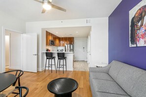 A modern apartment with a kitchen, dining area, and living room. - Treme Loft Condo: 1BR Harmony (New Orleans)