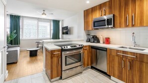 A modern kitchen with wooden cabinets, stainless steel appliances, a microwave, and a dishwasher.