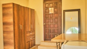 A kitchen with a wooden cabinet, a door, and a countertop. - Jardin Zen  (Tepoztlán)