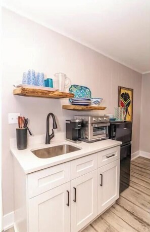 Oven, coffee/tea maker, cookware/dishes/utensils, dining tables