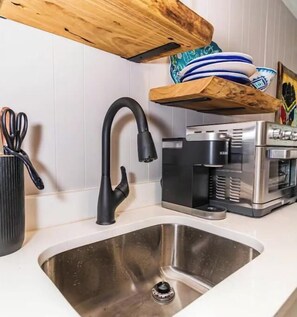 Oven, coffee/tea maker, cookware/dishes/utensils, dining tables
