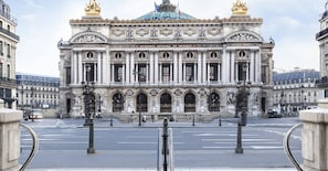 Stunning facade of the Conservatoire National Supérieur de Musique, featuring a classical architectural style with ornate sculptures and a central dome.