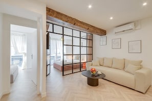 Relax in a stylish room with a large bed, sofa, and sliding glass door leading to a balcony.