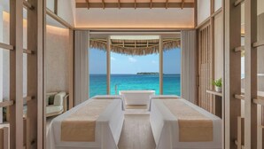 A room with a view of the ocean, a bathtub, and two massage tables. - JW Marriott Maldives Kaafu Atoll Island Resort (Hathaa Finolhu)