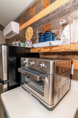 Oven, coffee/tea maker, cookware/dishes/utensils, dining tables